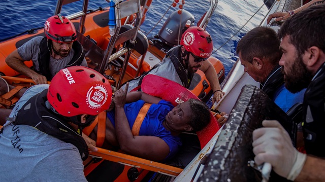 NBA Memphis player Marc Gasol and members of NGO Proactiva Open Arms rescue boat carry an African migrant in central Mediterranean Sea