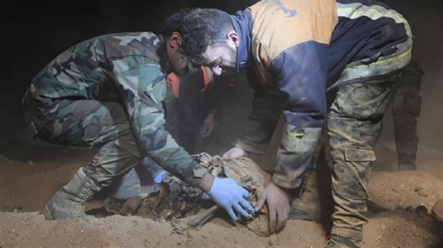 A body being exhumed by civil defense workers in Raqqa