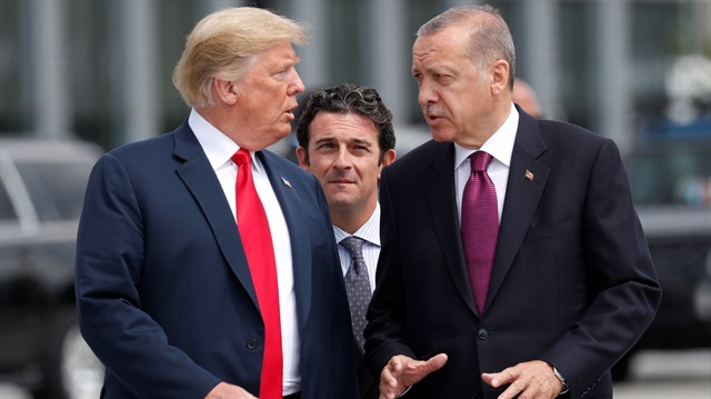 U.S. President Donald Trump and Turkish President Recep Tayyip Erdoğan gesture as they talk at the start of the NATO summit in Brussels, Belgium July 11, 2018. 