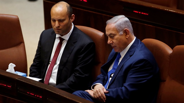 Israeli Prime Minister Benjamin Netanyahu sits next to Israeli Education Minister Naftali Bennett during a session in the Israeli Parliament.