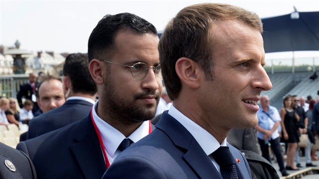 French President Emmanuel Macron walks ahead of his aide Alexandre Benalla at the end of the Bastille Day military parade in Paris, France, July.