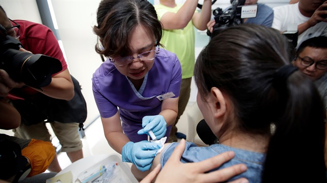 A woman from Beijing receives an injection of the Gardasil 9 human papillomavirus (HPV) vaccine, which, according to local media, is the first in mainland China, at a hospital in Boao, Hainan province, China.