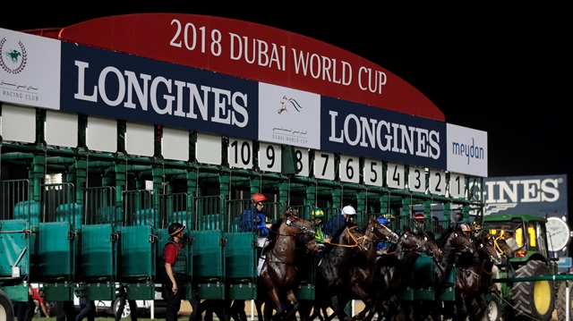 Jockeys compete during the eighth race
