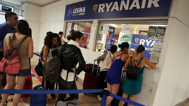 Stranded Ryanair passengers wait to receive information at Ryanair information desk, on the first day of a cabin crew strike held in several European countries, at the Adolfo Suarez Madrid Barajas airport in Madrid, Spain.