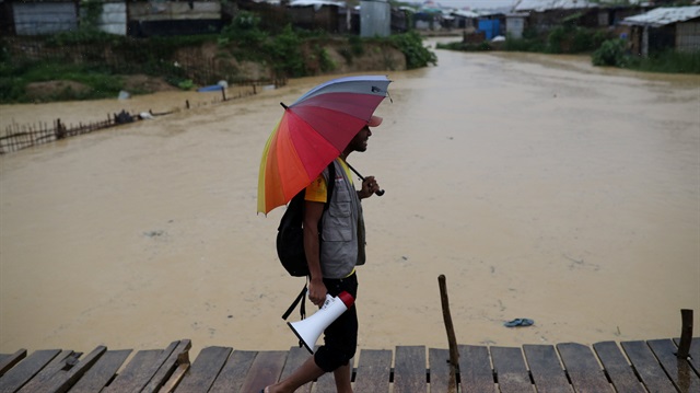 File photo: A volunteer of Bangladesh Red Crescent Society Bangladesh walks in the rain to call for the Rohingya refugees who have missing relatives in Myanmar or other countries, in Kutupalong camp in Cox's Bazar, Bangladesh