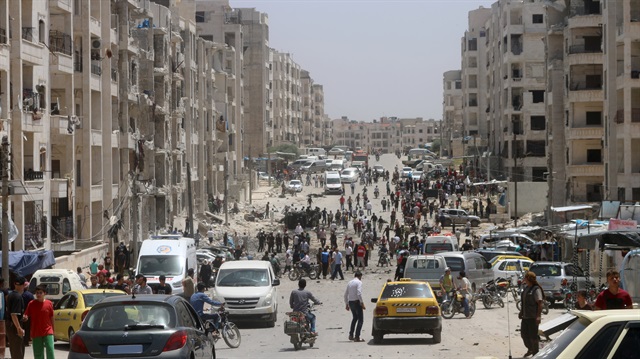 File photo: People inpect the damaged buildings after an explosion was carried out with a bomb-laden vehicle in Idlib