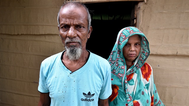 Abdul Suban, a farmer, and his wife pose for a photograph outside their home in Nellie village, in Morigaon district, in the northeastern state of Assam, India July 25, 2018. 