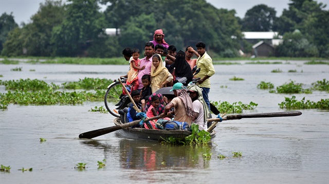 Flood affected villagers are transported on a boat 
