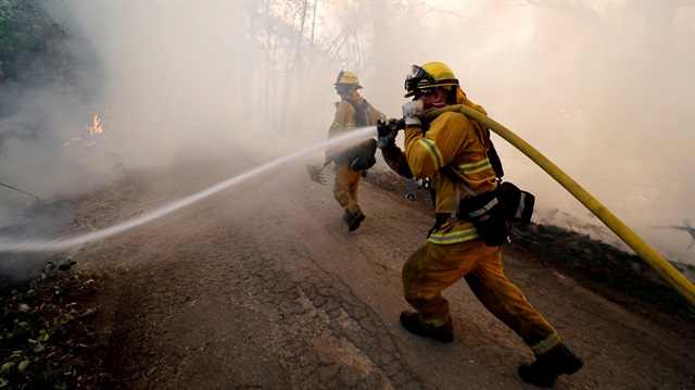 A firefighter knocks down hotspots to slow the spread of the River Fire (Mendocino Complex) in Lakeport, California, U.S. July 31, 2018. 