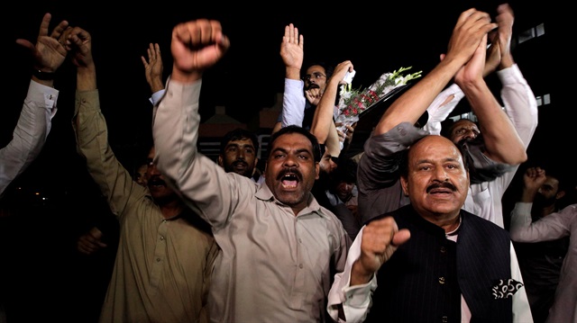 Supporters of former Prime Minister Nawaz Sharif chant slogans outside the cardiac center of Pakistan Institute of Medical Sciences (PIMS) where former Prime Minister Nawaz Sharif is shifted, in Islamabad, Pakistan.