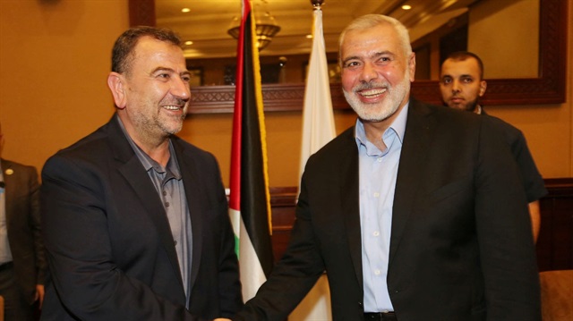 Hamas Chief Ismail Haniyeh shakes hands with Hamas Deputy Chief Saleh al-Arouri,