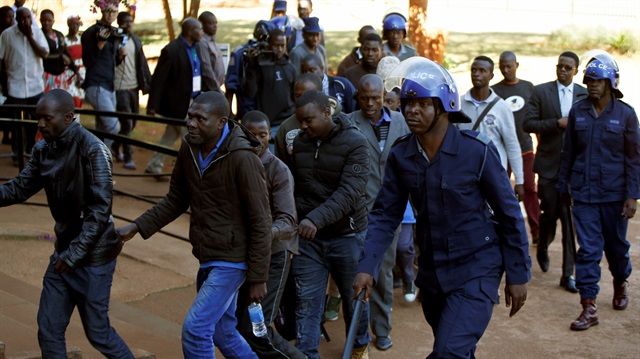 Some of the 16 people detained after police sealed off the building of Opposition Movement for Democratic Change (MDC) on Thursday, appear in court in the capital Harare, Zimbabwe