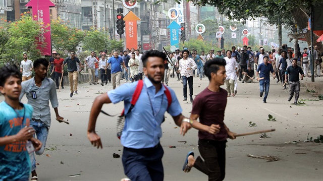 Students run back during clashes with unidentified miscreants while protesting over recent traffic accidents that killed a boy and a girl, in Dhaka, Bangladesh.