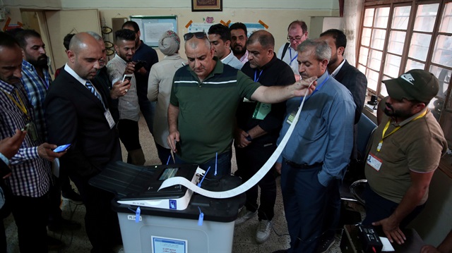 FILE PHOTO: Iraq's Independent High Electoral Commission employee closes a ballot box at a polling station during the parliamentary election in Baghdad, Iraq.