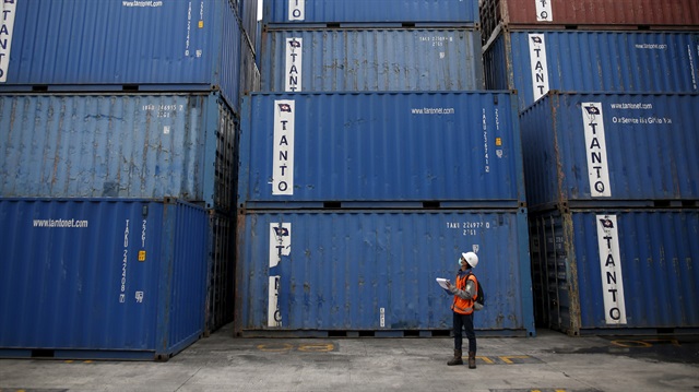 File photo: A worker tracks shipping containers in Tanjung Priok port in North Jakarta, Indonesia
