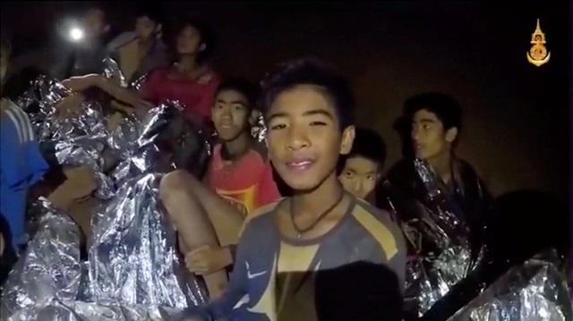 File Photo: Boys from the under-16 soccer team trapped inside Tham Luang cave covered in hypothermia blankets react to the camera in Chiang Rai, Thailand.