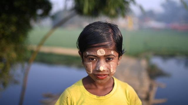 A Rohingya refugee girl named Zannat Ara, aged 10, poses for a photograph as she wears thanaka paste at Balukhali camp in Cox's Bazaar, Bangladesh