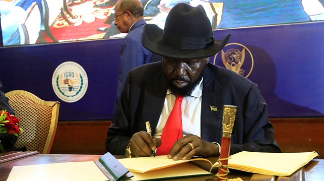 South Sudan's President Salva Kiir signs of a cease fire and power sharing agreement with South Sudan's rebel leader Riek Machar in Khartoum, Sudan.