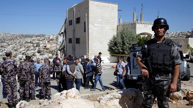 File Photo: Security forces gather near a damaged building at the city of Salt, Jordan.