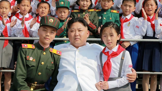 FILE PHOTO Schoolchildren stand beside North Korean leader Kim Jong Un as he arrives to attend "We Are the Happiest in the World", a performance of schoolchildren to celebrate the 70th founding anniversary of the Korean Children's Union (KCU), in this undated photo released by North Korea's Korean Central News Agency (KCNA) in Pyongyang.