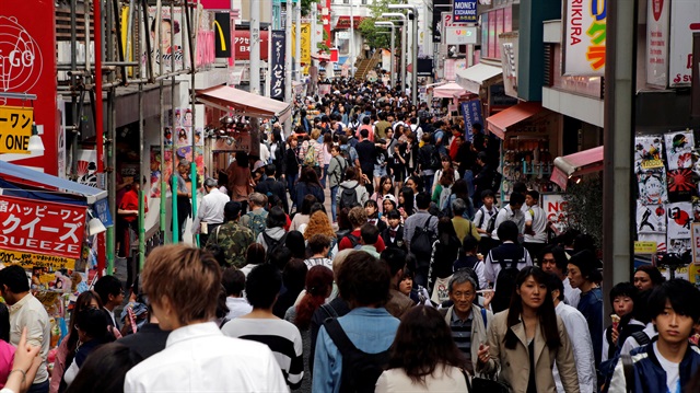 FILE PHOTO - People walk on a street in a busy shopping district in Tokyo, Japan.