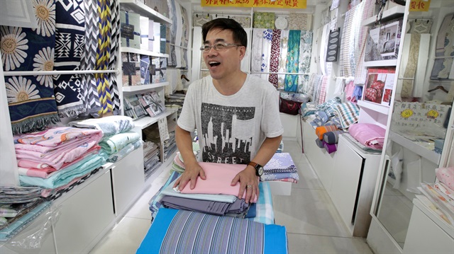 Vendor Zhao Baoxin, 61, speaks during a street interview on U.S.-China trade war at his shop