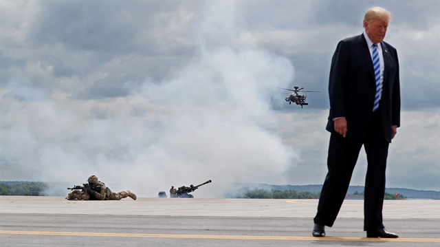 U.S. President Donald Trump observes a demonstration with U.S. Army 10th Mountain Division troops, an attack helicopter and artillery as he visits Fort Drum, New York, U.S., August 13, 2018. 