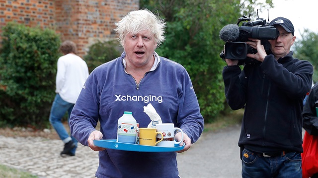 Britain's former Foreign Secretary Boris Johnson stands outside his home