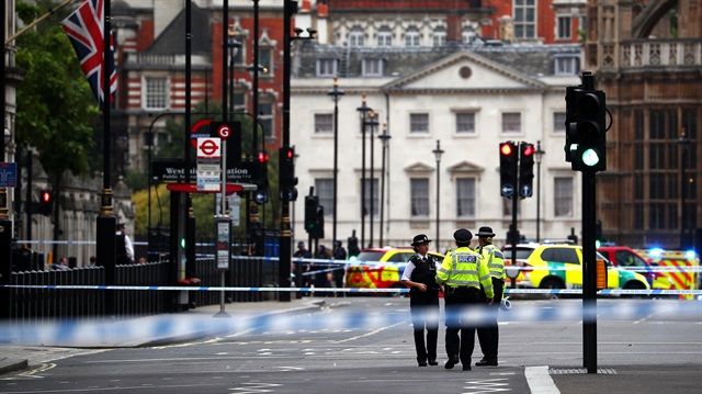 Police stand in the street after a car crashed outside the Houses of Parliament in Westminster, London, Britain, August 14, 2018. 