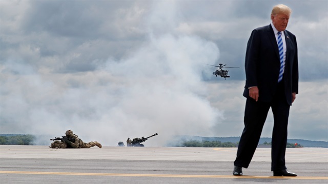 U.S. President Donald Trump observes a demonstration with U.S. Army 10th Mountain Division troops, an attack helicopter and artillery as he visits Fort Drum, New York, U.S., August 13, 2018. 
