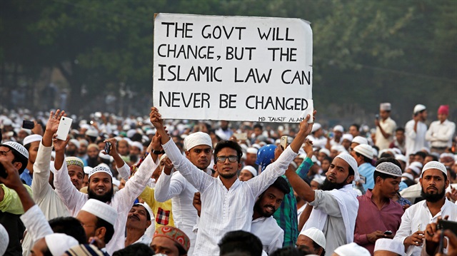 File photo:A man holds a banner during a rally organised by All India Muslim Personal Law Board (AIMPLB), in support of the Muslim Personal Law against what they say is central government's move to change it and impose the Uniform Civil Code across the country, in Kolkata, India