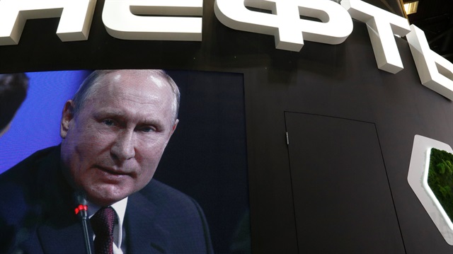 Russian President Vladimir Putin is seen on a screen at the stand of Russian state oil major Rosneft during the St. Petersburg International Economic Forum (SPIEF), Russia.
