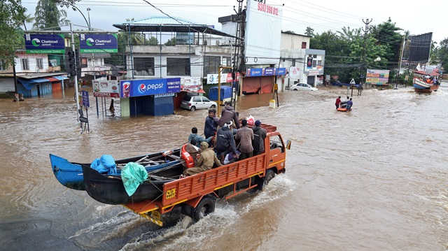A supply truck transporting boats to flooded areas moves through a water-logged road in Aluva in the southern state of Kerala, India, August 18, 2018.

