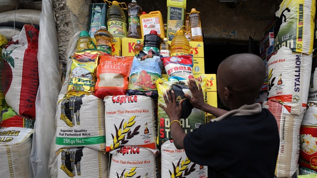 A vendor arranges bags of rice