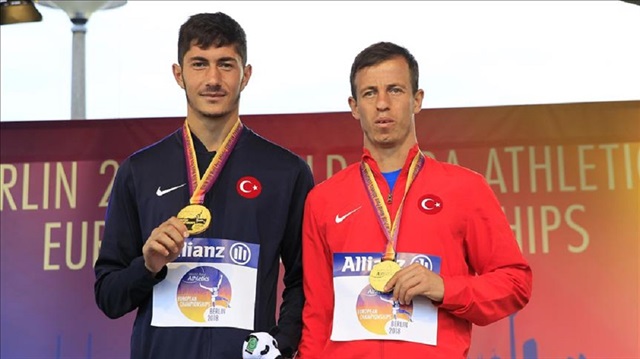 Mehmet Tunc of Turkey (R) and his guide Mehmet Tetik (L) pose for a photo with their gold medals after winning the Men's 200m T11 within the Berlin 2018 World Para Athletics European Championships in Berlin, Germany on August 25, 2018