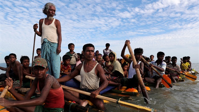 Rohingya refugees cross the Naf River with an improvised raft to reach to Bangladesh in Teknaf, Bangladesh, November 12, 2017.