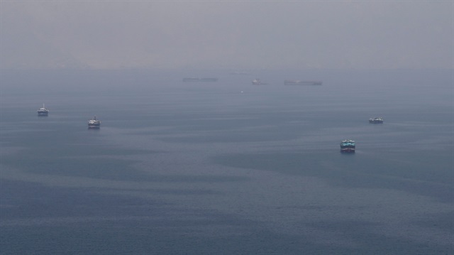Traditional Omani boats known as dhows, and cargo ships are seen sailing towards the Strait of Hormuz, off the coast of Musandam province, Oman, July 21, 2018.