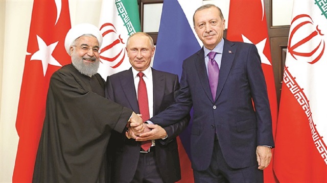 President Recep Tayyip Erdoğan holds hands with Russian, Iranian counterparts