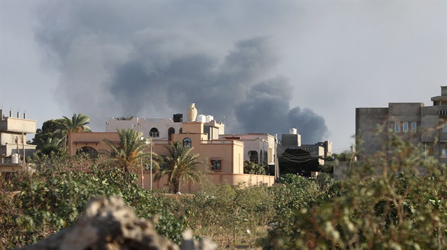 Smoke rises during heavy clashes between rival factions in Tripoli, Libya