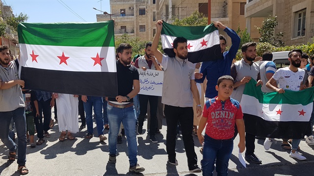 Syrian oppositions demanding Turkey to prevent attacks on Idlib, chant slogans as they protest against regime forces' possible attacks in Syria's Idlib province on August 31, 2018