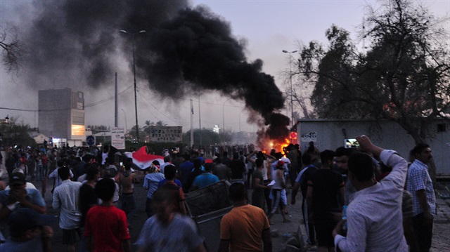 People gather during a protest near the main provincial government building because of the water pollution and poor services in Basra, Iraq 