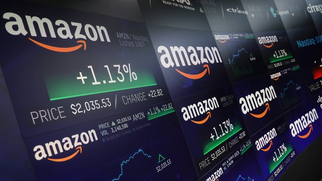 The Amazon.com logo and stock price information is seen on screens at the Nasdaq Market
