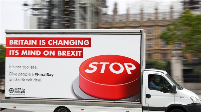 A van with a campaign poster about Brexit is driven around Parliament Square in London