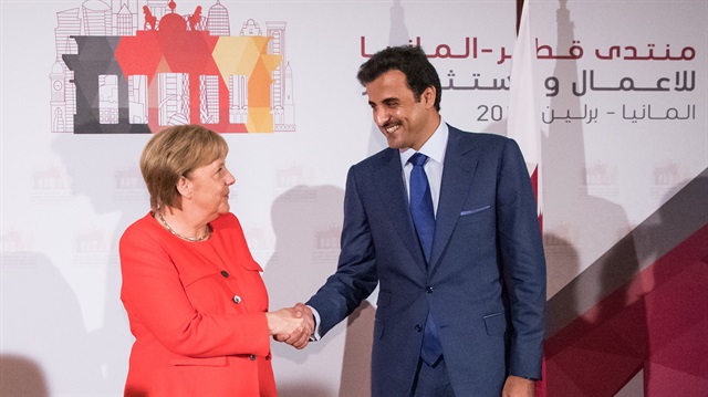 German Chancellor Angela Merkel welcomes Qatar's Emir Tamim bin Hamad al Thani before the start of a business conference in Berlin, Germany, September 7, 2018