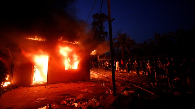 Iraqi protesters gather near the burnt Iranian Consulate in Basra, Iraq