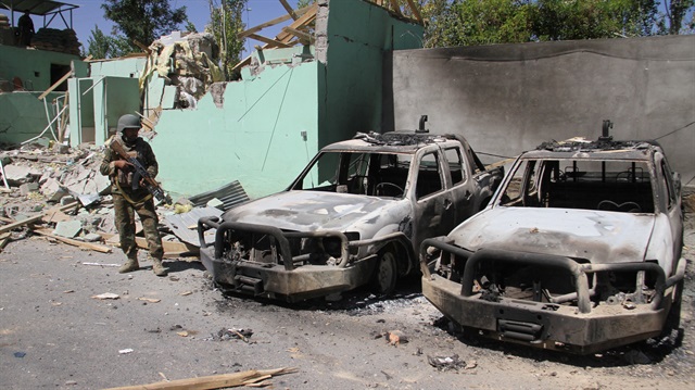 File photo: A member of the Afghan security forces stands guard next to damaged army vehicles after a Taliban attack in Ghazni city, Afghanistan August 15, 2018.