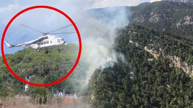 Antalya'da yangına müdahale eden helikopter pilotu yakıt ikmali için köye indi.