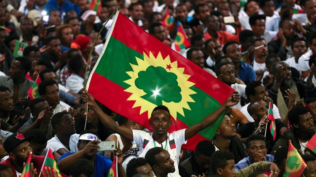 A man holds an Oromo Liberation Front (OLF) flag