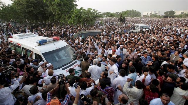 People gather near an ambuance as they attend funeral services for Kulsoom Sharif, the wife of former Prime Minister Nawaz Sharif who was temporarily released from prison, in Lahore, Pakistan September 14, 2018.