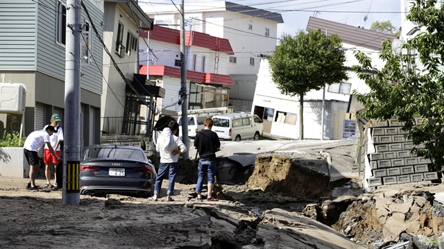 People look at an area damaged by an earthquake in Sapporo in Japan's northern island of Hokkaido, Japan, in this photo taken by Kyodo September 6, 2018. 